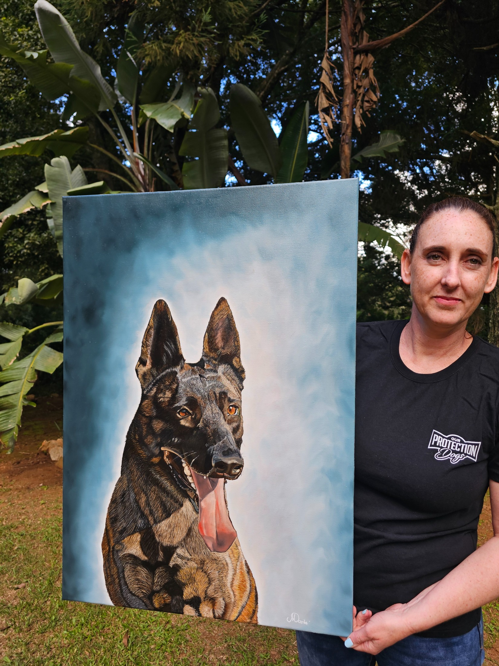 Marilé Sadler with a painting